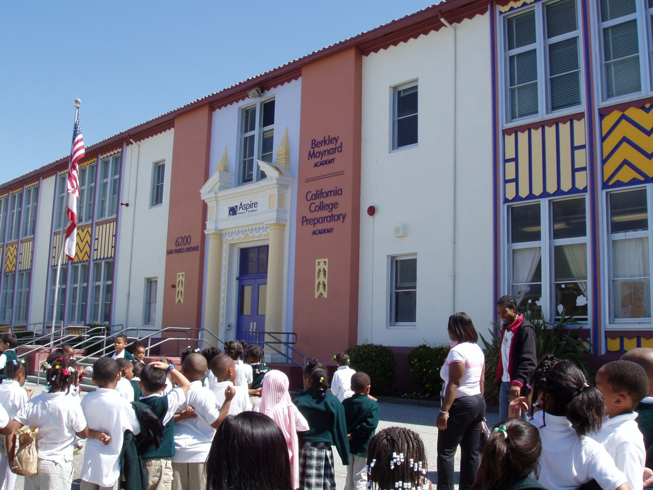 Students lined up outside school building, waiting to go inside